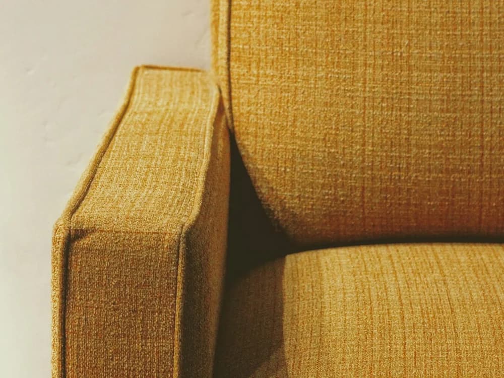 Tailored fabric cover fitted over a sofa